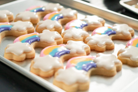 Decorating unicorn themed sugar cookies with royal icing.の写真素材