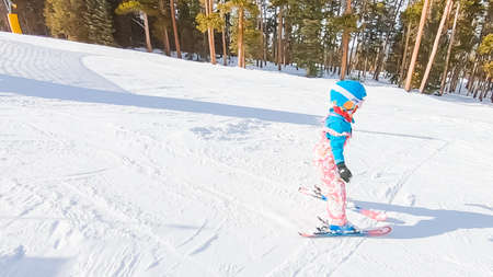 Keystoone, Colorado, USA-January 5, 2019 - Little girl learning how to ski down the hill on alpine mountains.のeditorial素材