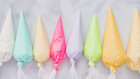 Step by step. Flat lay. Royal icing in plastic piping bags to decorate Easter cookies.