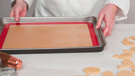 Step by step. Unbaked Easter sugar cookies arranged for baking on a baking sheet.