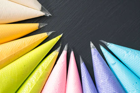 Variety of colors of royal icing in plastic piping bags.の写真素材