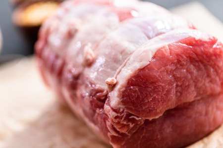 Close up view. Uncooked boneless pork roast on the brown butcher paper.の写真素材