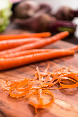 Peeling organic carrots to make beet soup.の写真素材
