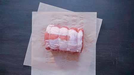 Flat lay. Step by step. Boneless pork roast on brown butcher paper.の写真素材