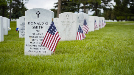 Denver, Colorado, USA-May 26, 2019 - Small American Flags next to white marble gravestones at the ...