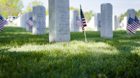Denver, Colorado, USA-May 26, 2019 - Small American Flags next to white marble gravestones at the  Fort Logan National Cemetery on Memorial Day.のeditorial素材