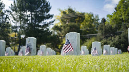 Denver, Colorado, USA-May 26, 2019 - Small American Flags next to white marble gravestones at the  Fort Logan National Cemetery on Memorial Day.のeditorial素材