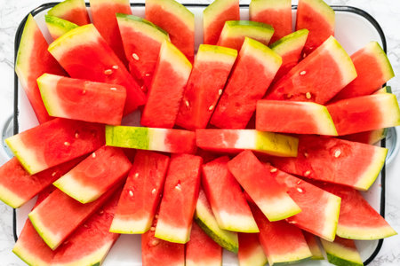 Small slices of red seedless watermelon on the tray for the party.の写真素材