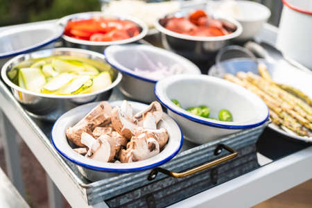 Cooking pizza on an outdoor gas grill on backyard in the Summer.の写真素材