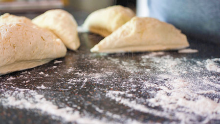 Rolling out pizza dough for individual small pizzas.