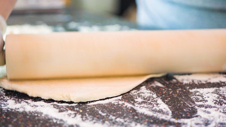 Rolling out pizza dough for individual small pizzas.