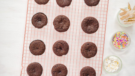 Flat lay. Step by step. Cooling freshly baked chocolate cupcakes on a cooling rack.