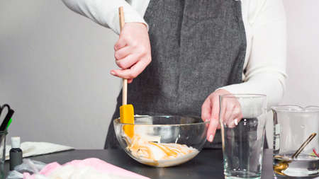 Step by step. Mixing in food coloring into the royal icing to decorate sugar cookies.の写真素材