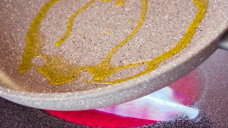 Frying organic egg in olive oil on frying pan.の写真素材