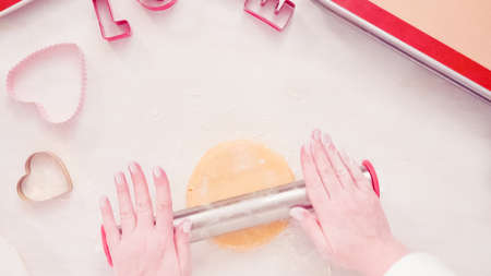 Flat lay. Step by step. Rolling sugar cookie dough with metal rolling pin.の写真素材