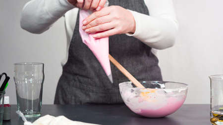 Step by step. Pouring royal icing into the piping bag to decorate sugar cookies.の写真素材
