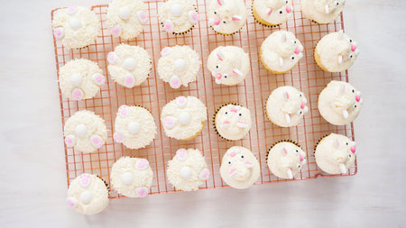Flat lay. Step by step. Decorating vanilla cupcakes with white buttercream frosting for Easter.