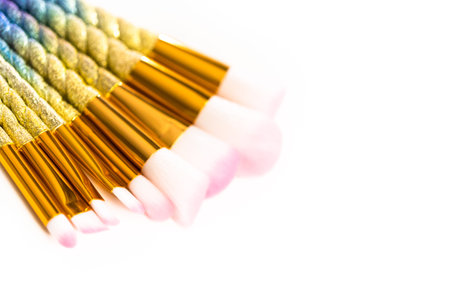 Flat lay. Unicorn-themed makeup brush set on a white background.