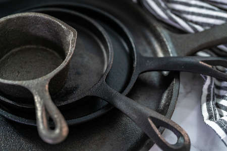 Close up view. Variety of cast iron frying pans on a marble background.の写真素材