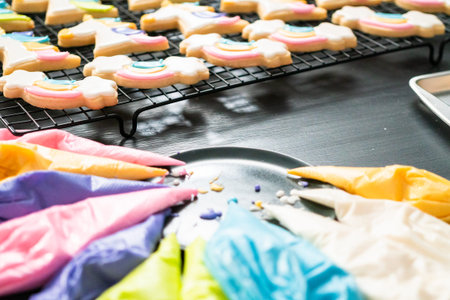 Close up. Colorful piping bags with royal ising on the table.