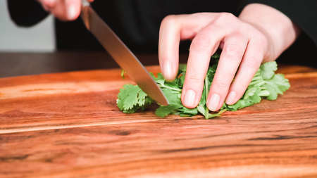 Step by step. Slicing fresh parsley to garnish beet soup, borscht.の写真素材