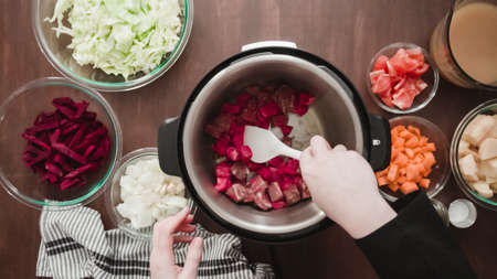 Step by step. Flat lay. Cooking beet soup, borscht with organic vegetables in multicooker.の写真素材
