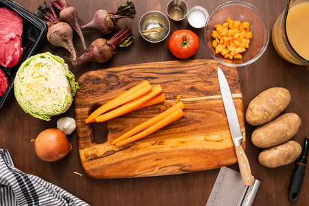 Flat lay. Peeling organic carrots to make beet soup.の写真素材