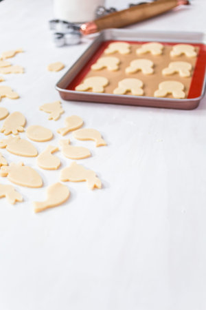 Unbaked Easter sugar cookies on a white table.