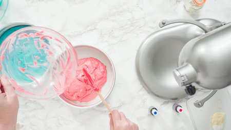 Step by step. Flat lay. Mixing food coloring into a cake batter to bake a three-layer vanilla cake.