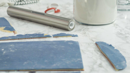 Step by step. Rolling out dough with a rolling pin to bake red, white, and blue pinwheel sugar...