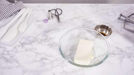 Step by step. Mixing ingredients in a standing kitchen mixer to prepare cream cheese frosting.の写真素材