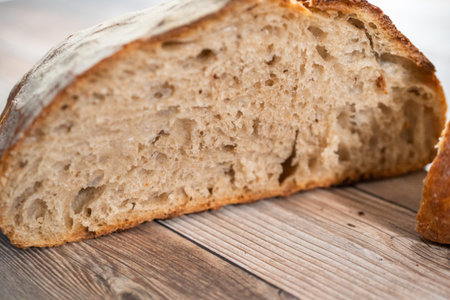 Sliced baked sourdough rye loaf of bread.
