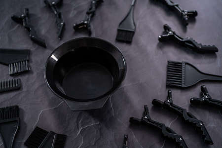 Black hair color dye kit with mixing bowl on a black background.の写真素材