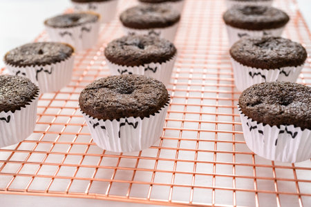 Cooling chocolate cupcakes before decorating them with icing.の写真素材