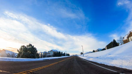 Driving through typical American suburban neighborhood on a cold Winter morning.の写真素材