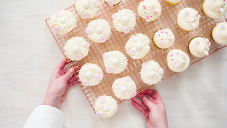 Flat lay. Step by step. Decorating vanilla cupcakes with white buttercream frosting for Easter.