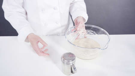 Knitting dough by hand to bake cinnamon rolls.の写真素材
