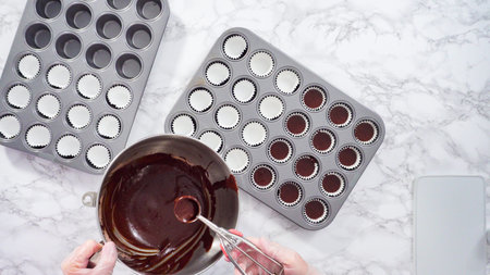 Flat lay. Step by step. Scooping cupcake batter into mini cupcake lines to bake mini chocolate...