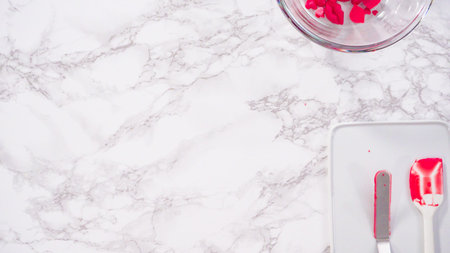 Flat lay. Step by step. Making chocolate hearts and kisses from melted red chocolate chips.