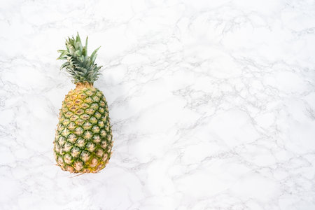Flat lay. Whole pineapple on a marble background.の写真素材