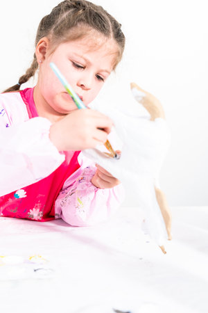 Little girl working on her art project for distance learning at home during COVID-19 pendemic.の写真素材