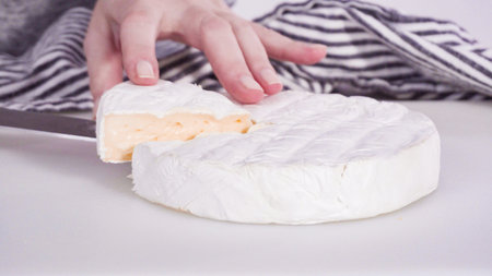 Large slice of gourmet cheese on a white background.の写真素材