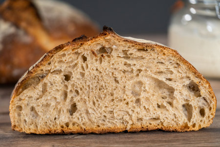 Sliced baked sourdough rye loaf of bread.