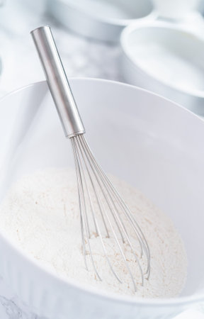 Mixing flour with other dry ingredients to bake a cake.