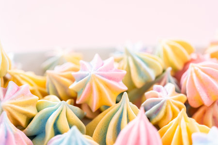 Multicolored unicorn meringue cookies on a white serving plate.の写真素材