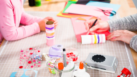 Kids papercraft. Making paper bugs out of the empty toilet paper rolls and construction paper.の写真素材