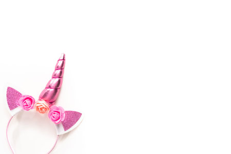 Flat lay. Colorful unicorn headband on a white background.