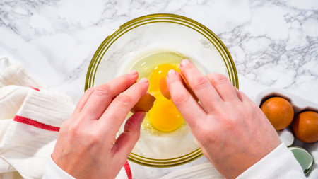 Step by step. Flat lay. Mixing ingredients in a glass mixing bowl to prepare bacon and cheese egg muffin.の写真素材