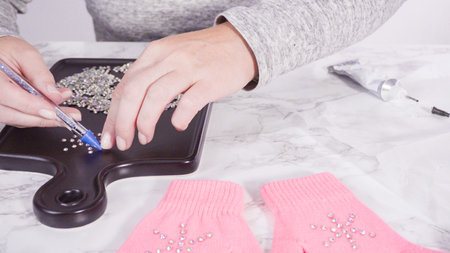 Rhinestone pink kids gloves with snowflake shapes.の写真素材