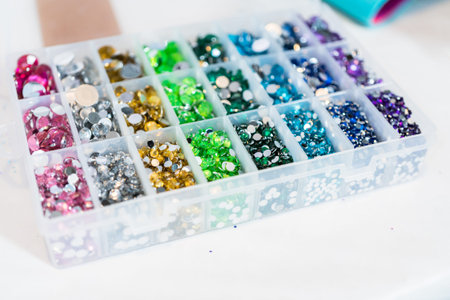 Color and size variety of rhinestones in the craft box.